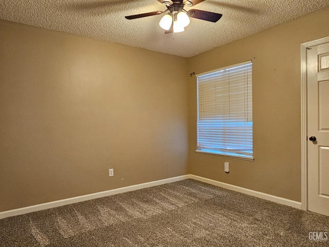 spare room featuring a textured ceiling, carpet floors, and ceiling fan