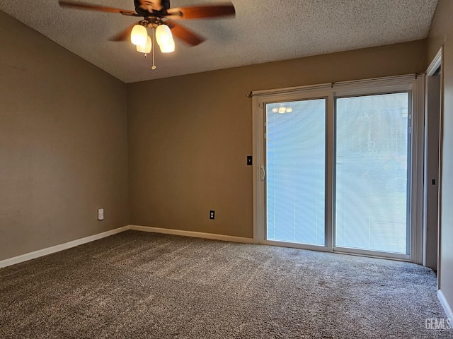 carpeted spare room featuring a textured ceiling and ceiling fan