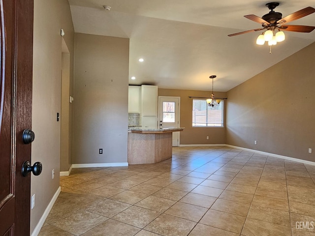 interior space with ceiling fan with notable chandelier