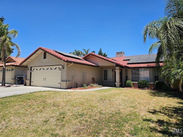 view of front facade featuring solar panels, a front lawn, and a garage