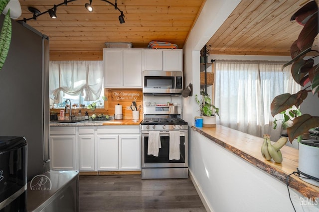 kitchen featuring appliances with stainless steel finishes, wood ceiling, dark wood-type flooring, sink, and white cabinetry