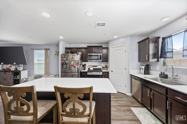 5803 Vespucci Ave, Bakersfield, CA 93313 - kitchen with stainless steel appliances, light wood-style floors, dark brown cabinets, light countertops, and recessed lighting