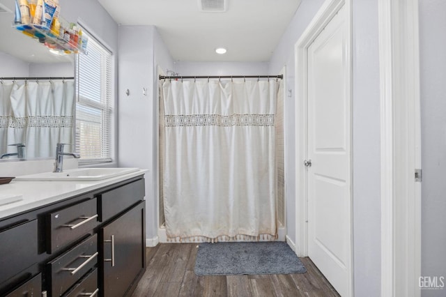 5803 Vespucci Ave, Bakersfield, CA 93313 - bathroom with wood finished floors, vanity, curtained shower, and recessed lighting