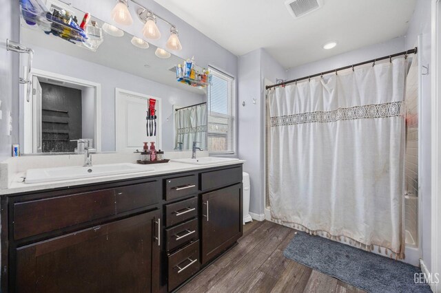 5803 Vespucci Ave, Bakersfield, CA 93313 - full bath with wood finished floors and double vanity