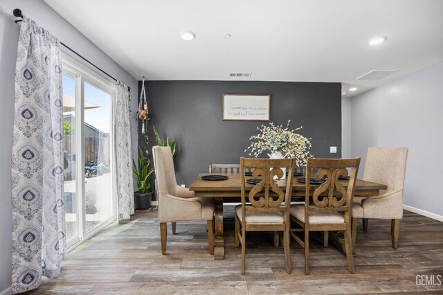 5803 Vespucci Ave, Bakersfield, CA 93313 - dining room with an accent wall, wood finished floors, and recessed lighting