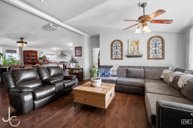 living area featuring ceiling fan, visible vents, vaulted ceiling, and dark wood-type flooring