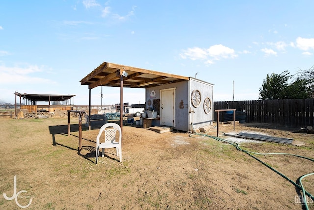 view of yard with an outbuilding and fence