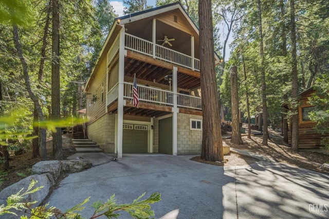 view of front of house with a garage and ceiling fan