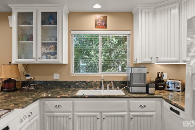 kitchen with white cabinets, white dishwasher, a wealth of natural light, and sink