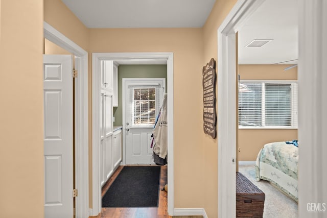 hallway with carpet floors