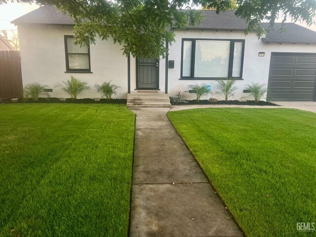 1312 Townsley Ave, Bakersfield, CA 93304 - single story home featuring a front yard, an attached garage, stucco siding, and roof with shingles