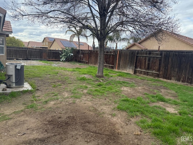 view of yard featuring central AC and a fenced backyard