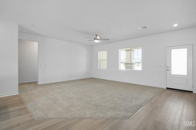 interior space with visible vents, baseboards, and light wood finished floors