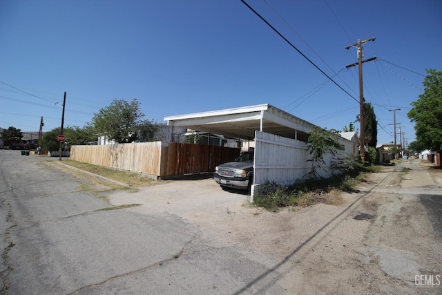 view of property exterior featuring fence and driveway
