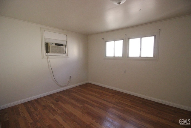 unfurnished room featuring baseboards and dark wood finished floors