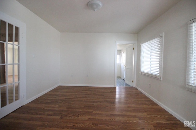 unfurnished room featuring baseboards and wood finished floors