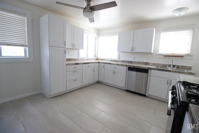 kitchen featuring a sink, range with gas stovetop, a ceiling fan, a wealth of natural light, and stainless steel dishwasher