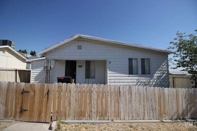 bungalow-style house with fence and central air condition unit