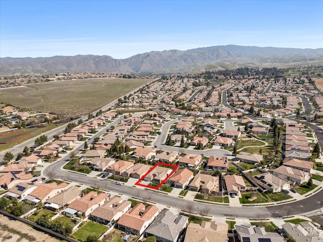 drone / aerial view featuring a residential view and a mountain view