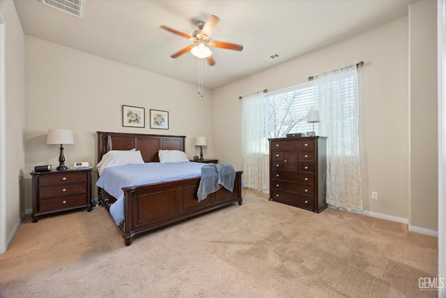 bedroom with light colored carpet, visible vents, ceiling fan, and baseboards