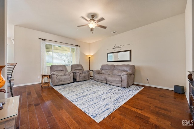 living area featuring dark wood-style floors, visible vents, baseboards, and a ceiling fan