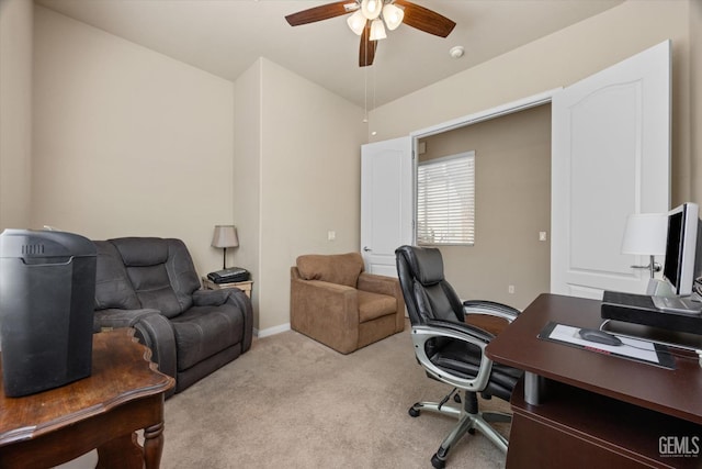 office area featuring light carpet, ceiling fan, and vaulted ceiling