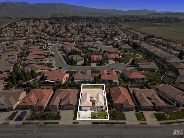 birds eye view of property with a residential view and a mountain view