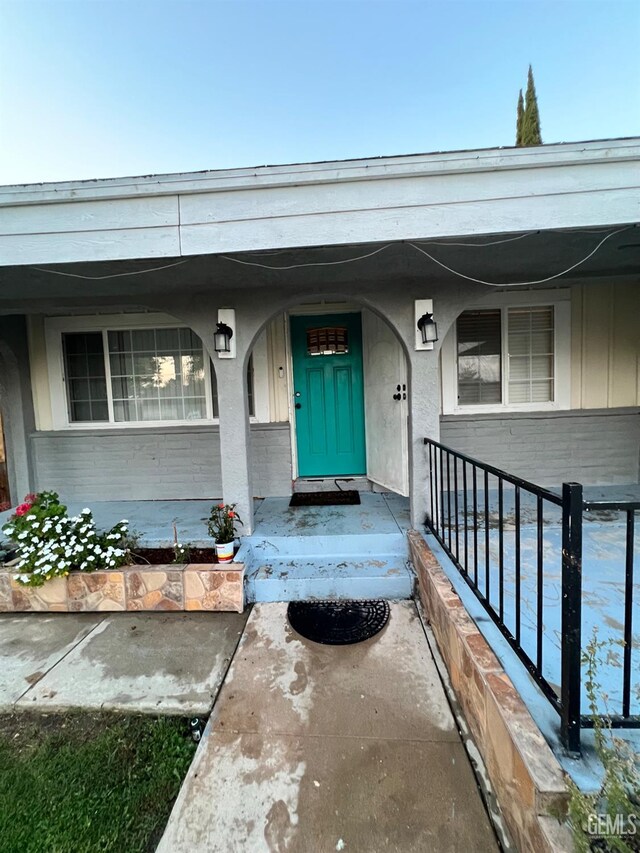 1208 W Point Dr, Bakersfield, CA 93305 - property entrance featuring a porch and brick siding