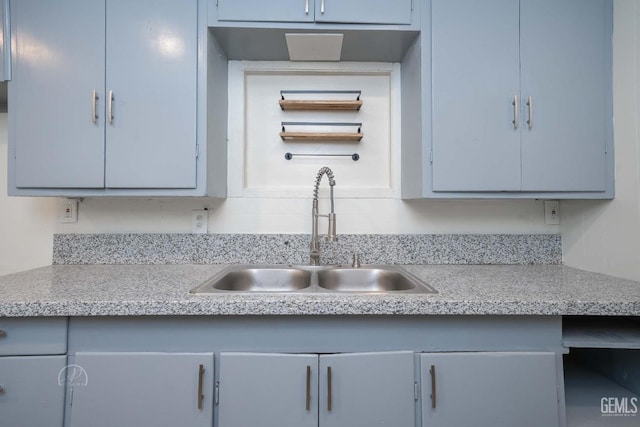 kitchen featuring light countertops and a sink