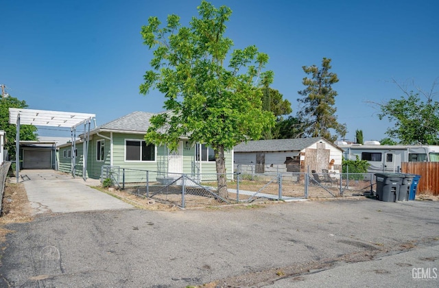 ranch-style home with fence private yard, a garage, a gate, a shingled roof, and concrete driveway