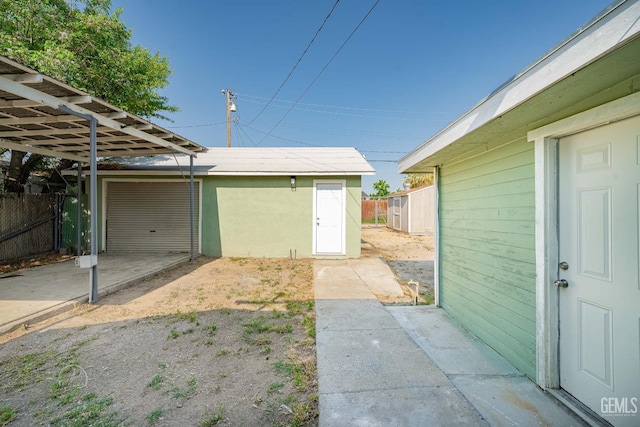 detached garage featuring fence