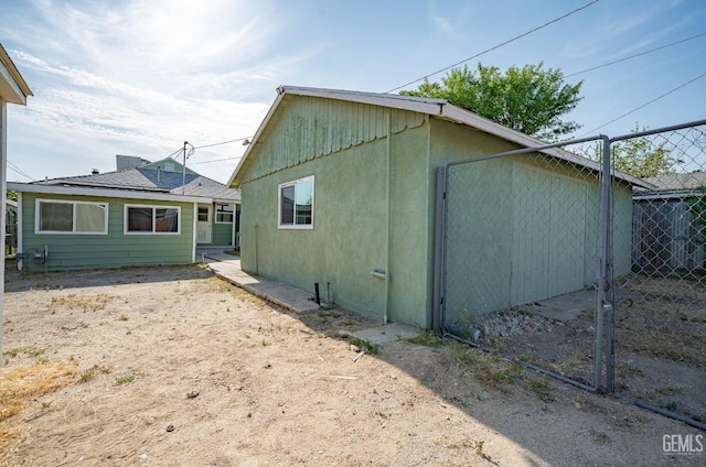 exterior space featuring fence and stucco siding