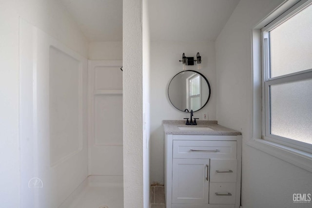 full bathroom with vanity and a stall shower