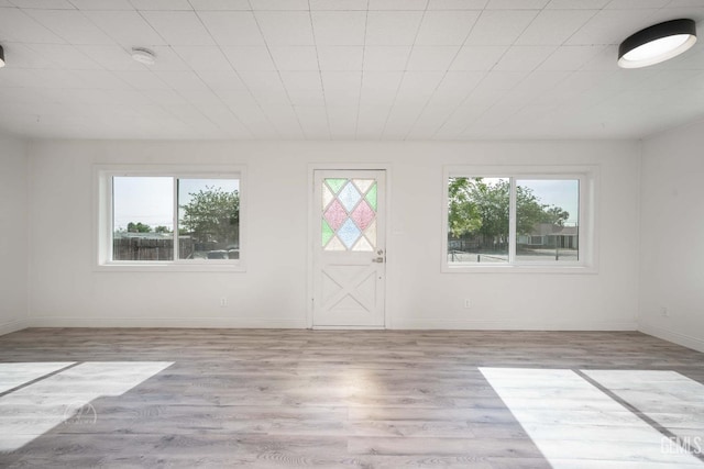 interior space featuring baseboards and wood finished floors