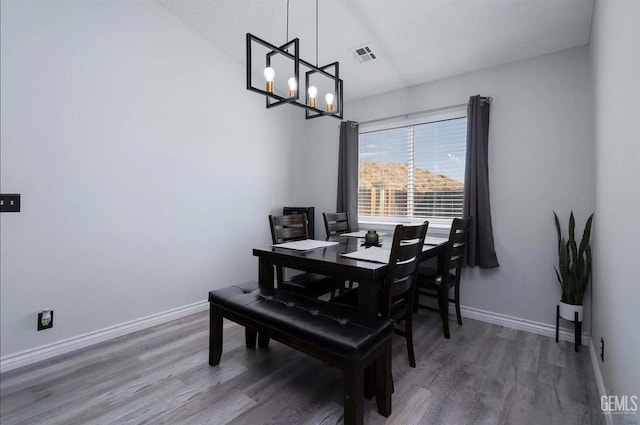 6513 Derby Dr, Bakersfield, CA 93306 - dining area featuring a chandelier, wood finished floors, and lofted ceiling