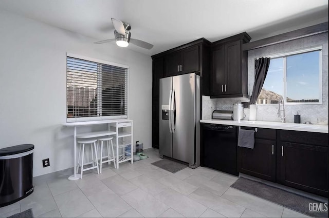 6513 Derby Dr, Bakersfield, CA 93306 - kitchen with stainless steel fridge, black dishwasher, a ceiling fan, light countertops, and dark cabinetry