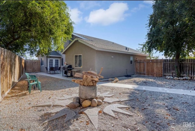 6513 Derby Dr, Bakersfield, CA 93306 - back of property with a patio area, a fenced backyard, french doors, and stucco siding