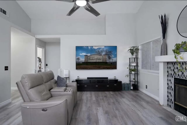 6513 Derby Dr, Bakersfield, CA 93306 - living room featuring wood finished floors, ceiling fan, and a tiled fireplace