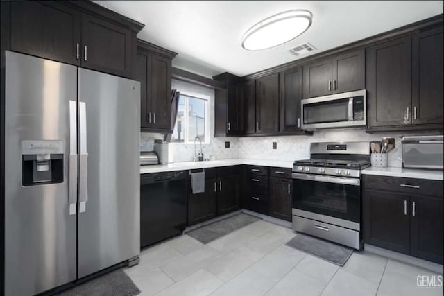 6513 Derby Dr, Bakersfield, CA 93306 - kitchen featuring appliances with stainless steel finishes, backsplash, light countertops, and light tile patterned flooring