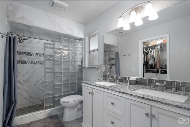 6513 Derby Dr, Bakersfield, CA 93306 - bathroom featuring a shower stall, double vanity, and a walk in closet