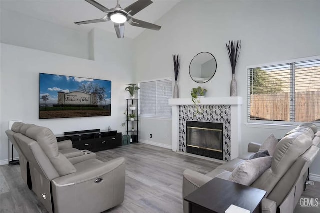 6513 Derby Dr, Bakersfield, CA 93306 - living area featuring wood finished floors, a ceiling fan, a tiled fireplace, and high vaulted ceiling