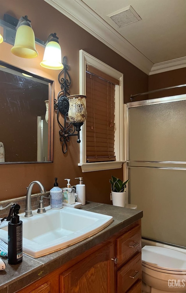 full bathroom with visible vents, an enclosed shower, ornamental molding, and vanity