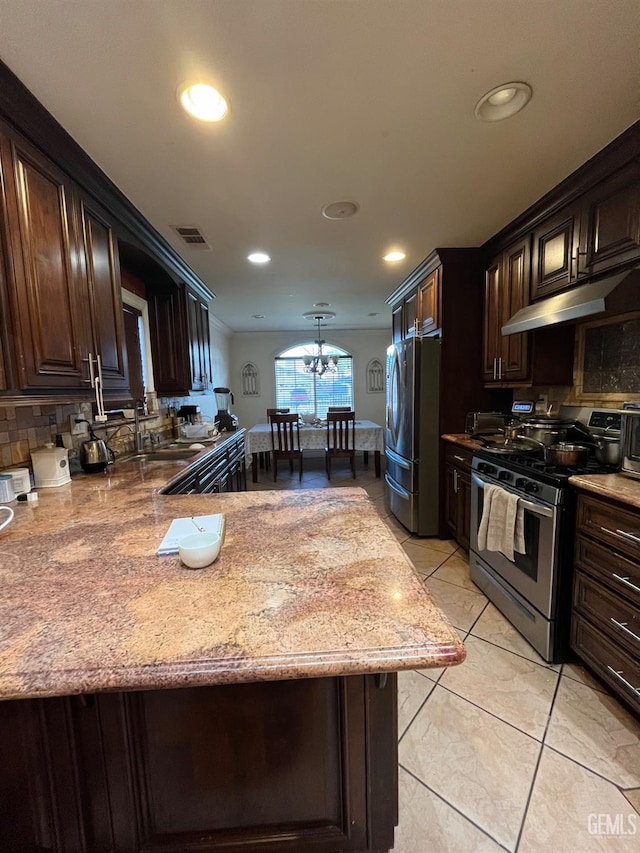 kitchen featuring visible vents, dark brown cabinets, under cabinet range hood, stainless steel appliances, and a sink