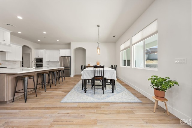 506 Rosehaven Ln, Tehachapi, CA 93561 - dining space with recessed lighting, arched walkways, light wood finished floors, and baseboards