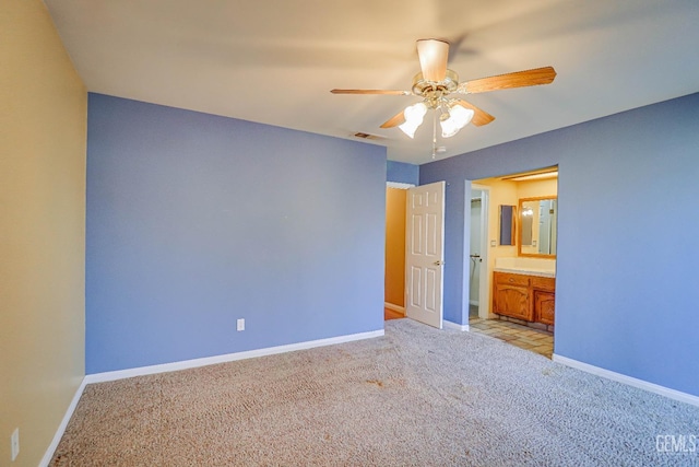 unfurnished bedroom with connected bathroom, light colored carpet, and ceiling fan