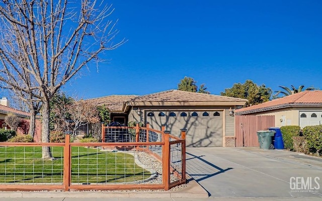 view of front of home with a garage and a front lawn