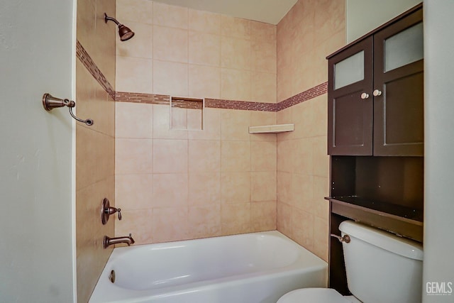 bathroom featuring toilet and tiled shower / bath combo