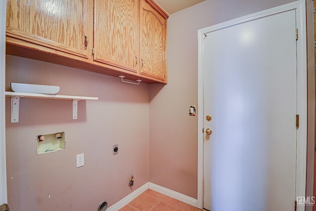 clothes washing area featuring washer hookup, light tile patterned floors, cabinets, and hookup for an electric dryer