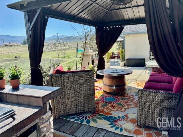 22824 Mariposa Rd, Tehachapi, CA 93561 - wooden terrace featuring a gazebo, a mountain view, and a patio area