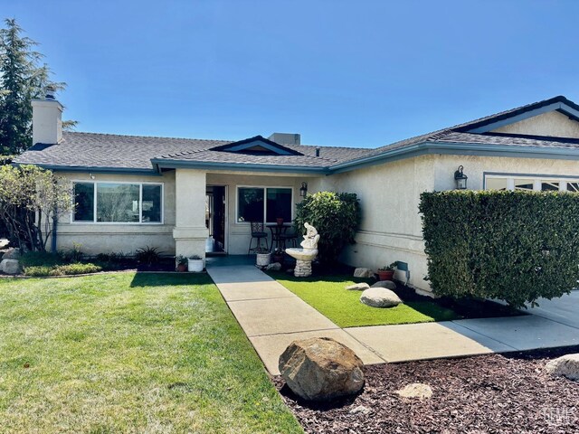 22824 Mariposa Rd, Tehachapi, CA 93561 - single story home with a front yard, stucco siding, roof with shingles, and a chimney